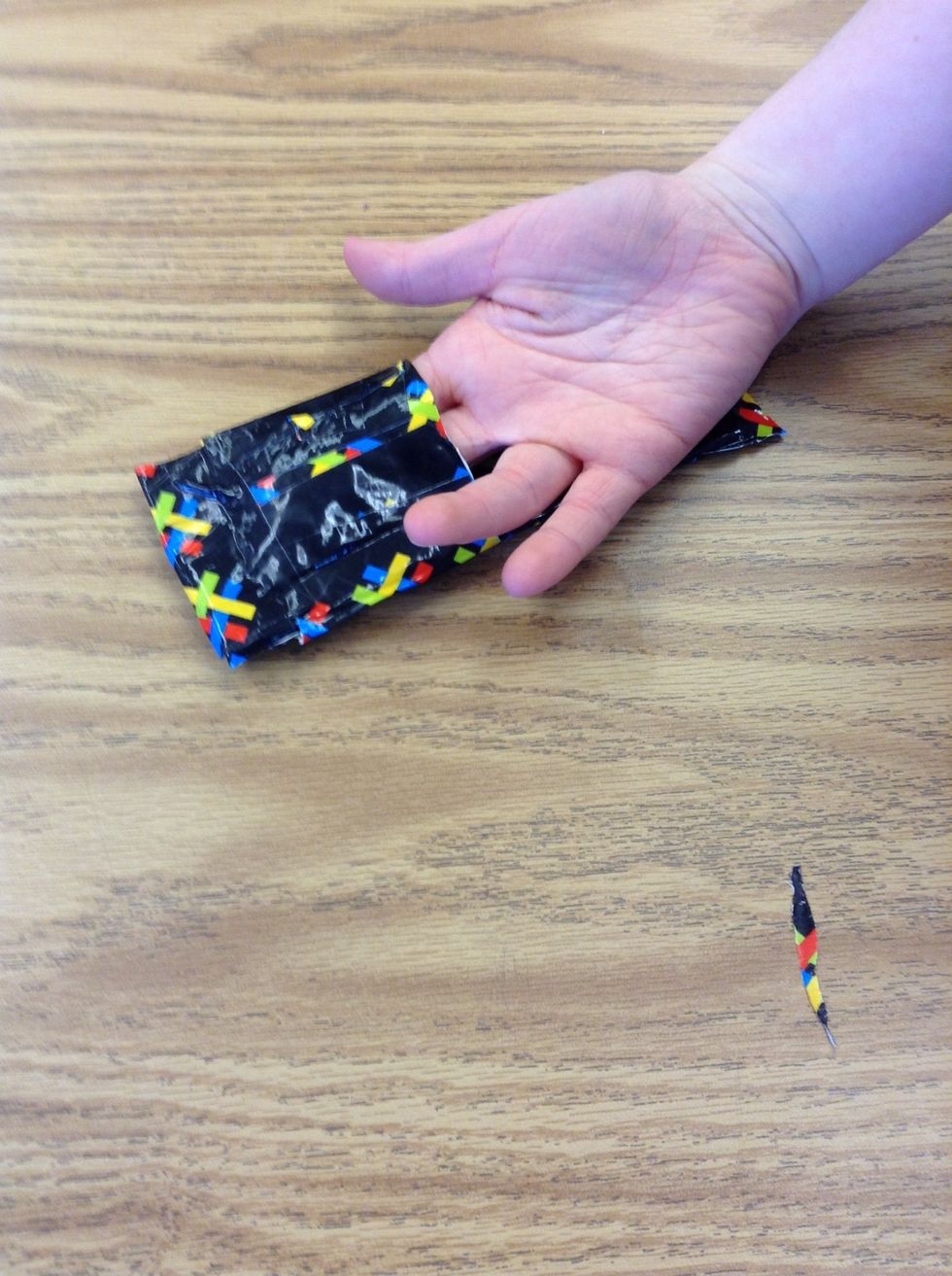 Then, put that on one side of your wallet. Tape down the top, bottom, and left side.