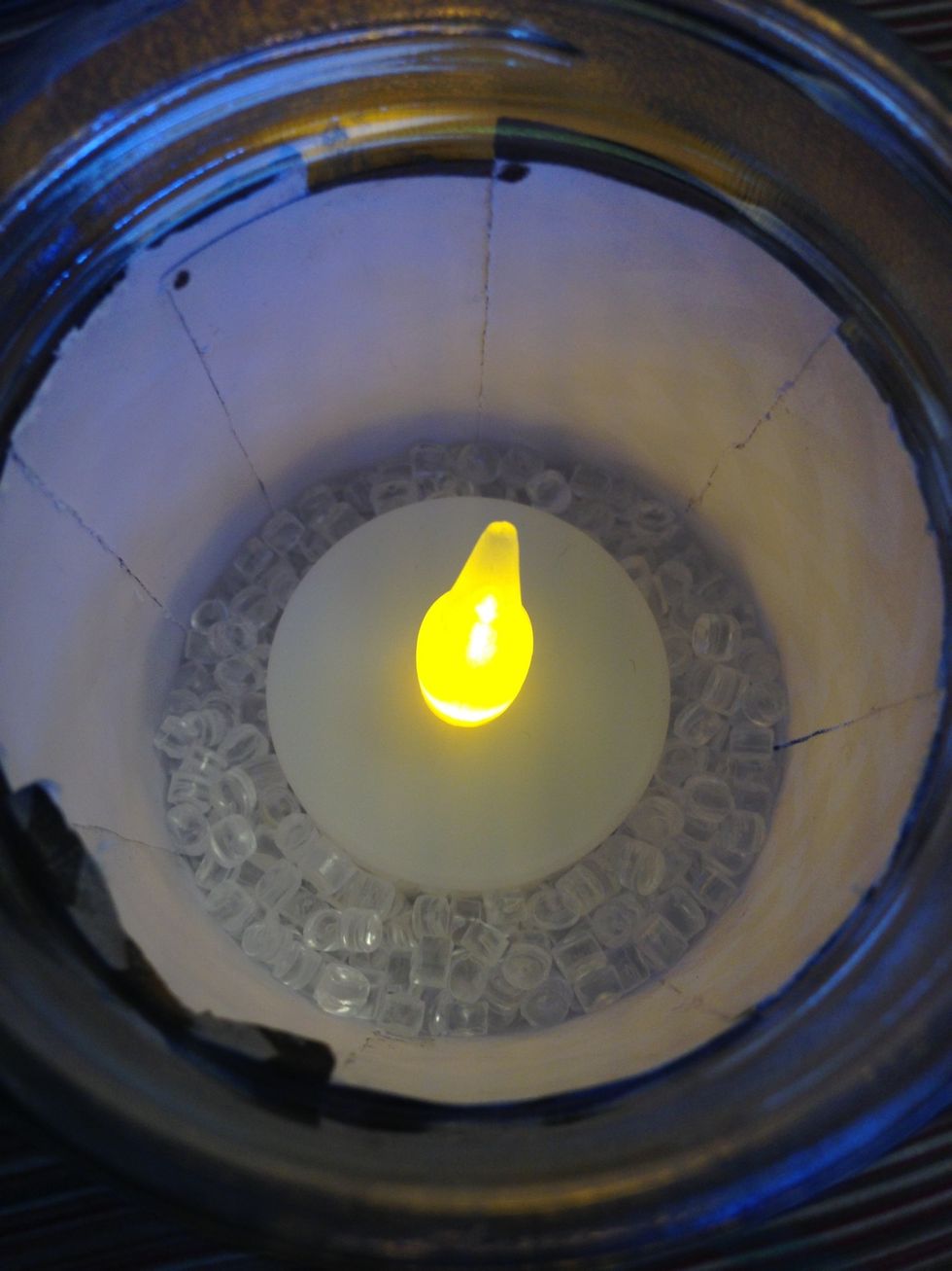 Then put the battery-operated tea light on too of the bubble beads.