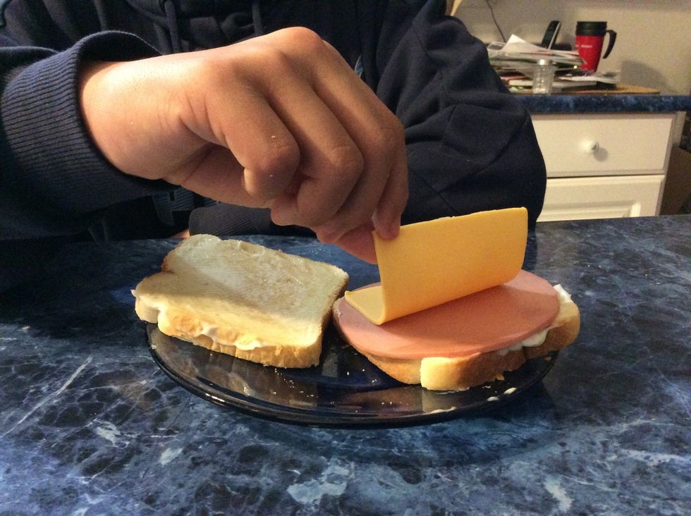 Then put the cheese on top of the bologna.