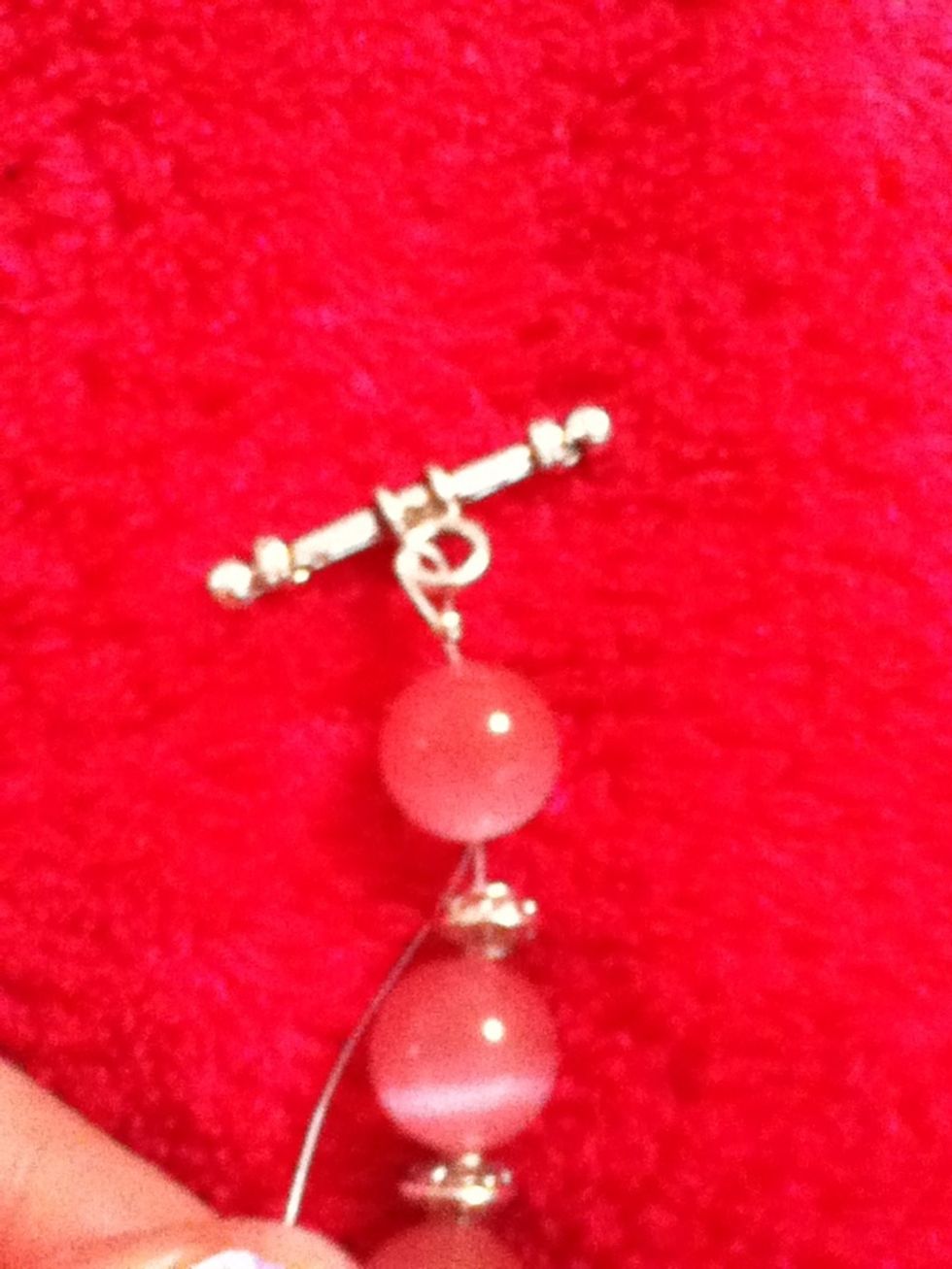 Then put the extra wire through the crimp bead and 1 or 2 beads.