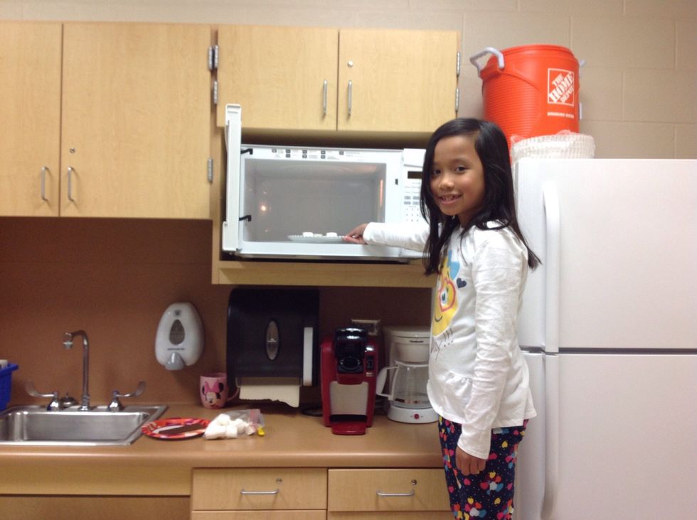 Then, put the marshmallows in the microwave for one minute. Then, you place the marshmallows on top of the chocolate.