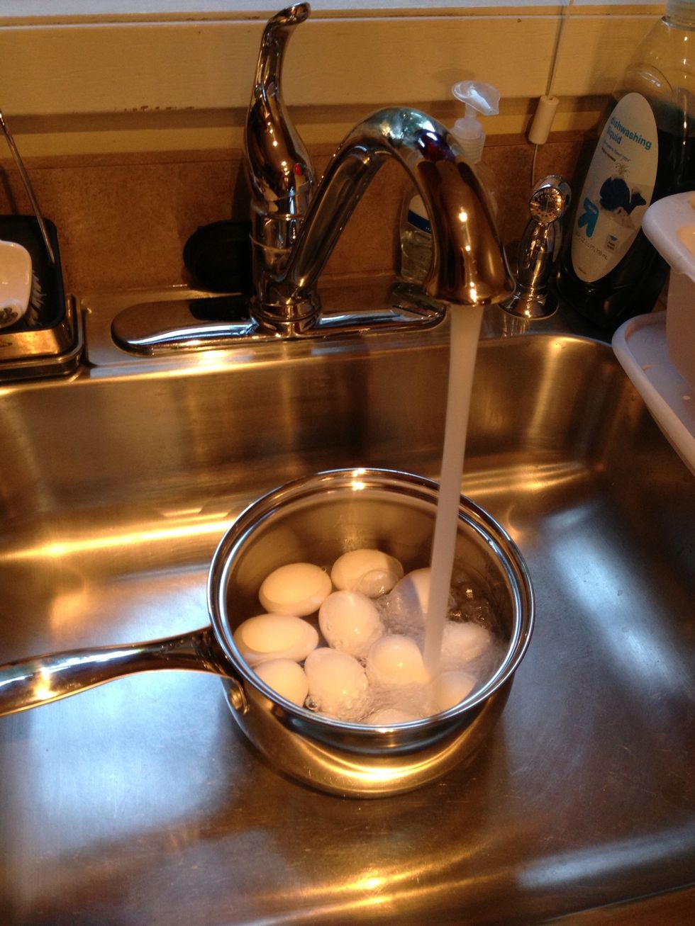 Then, put the pot in the sink and fill it with water. Make sure the water covers all the eggs.