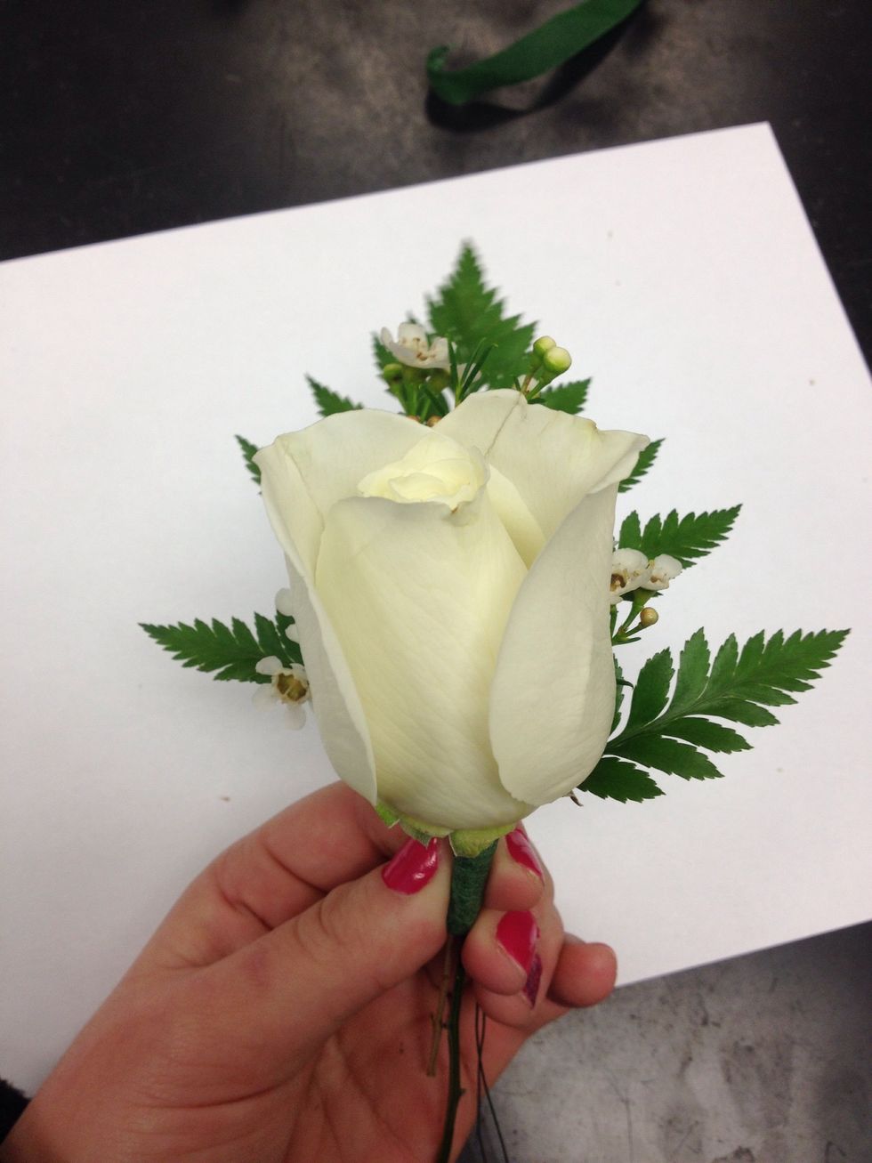 Then, put the Rose on top of the Waxflower and Baker's Fern.