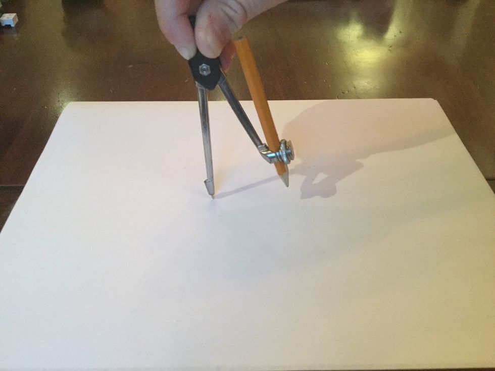 Then put the sharp end of the compass where you want the middle of the circle to be.
