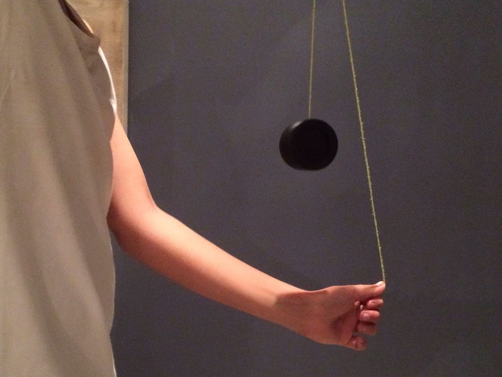 Then put the top part of the string behind the yoyo