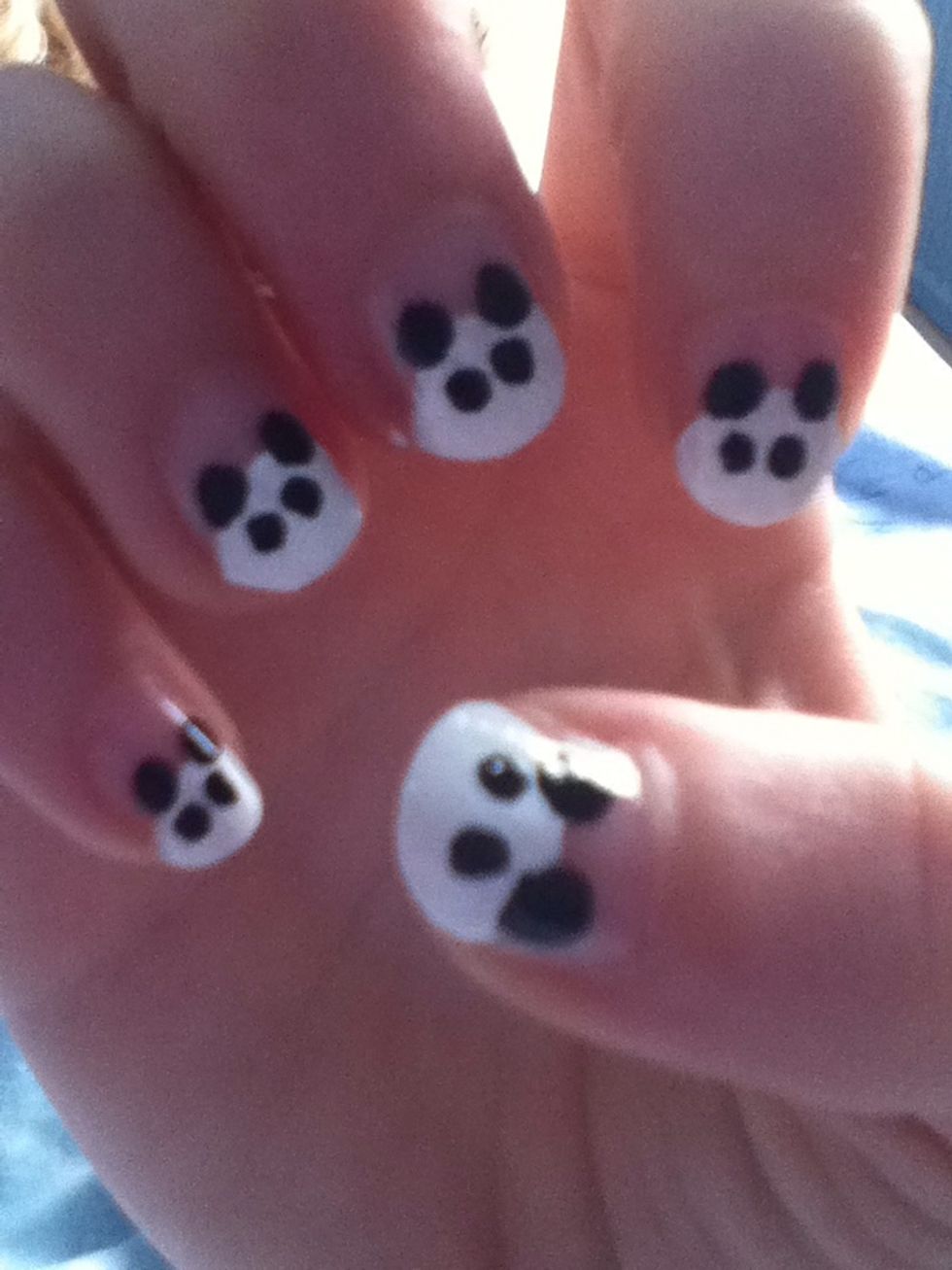 Then put two smaller black dots for the background of the eyes. Make sure these are big enough to put two more sets of dots in.