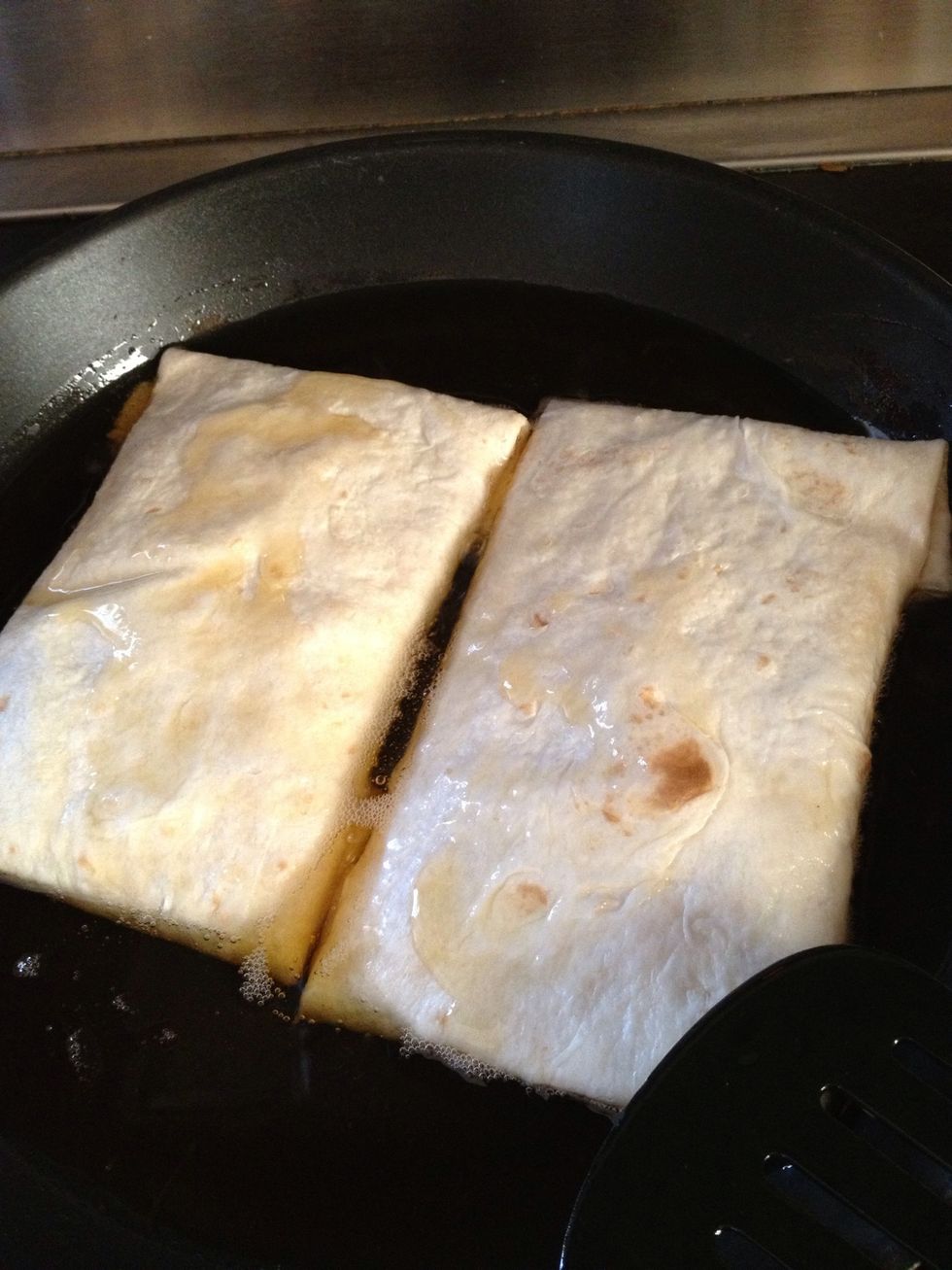 Then put your chimichangas in let it fry on very low temp then turn over. Be careful I recommend using two spoons and wearing a apron :)