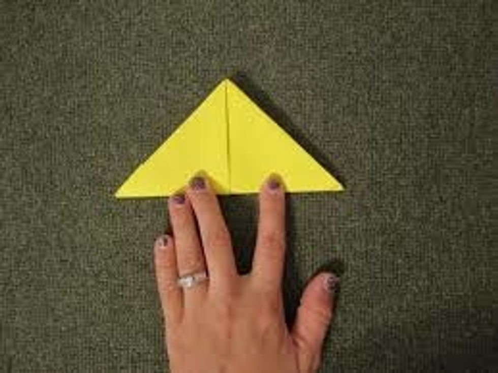 Then put your hand under the paper and fold it into a square like you did last time.
