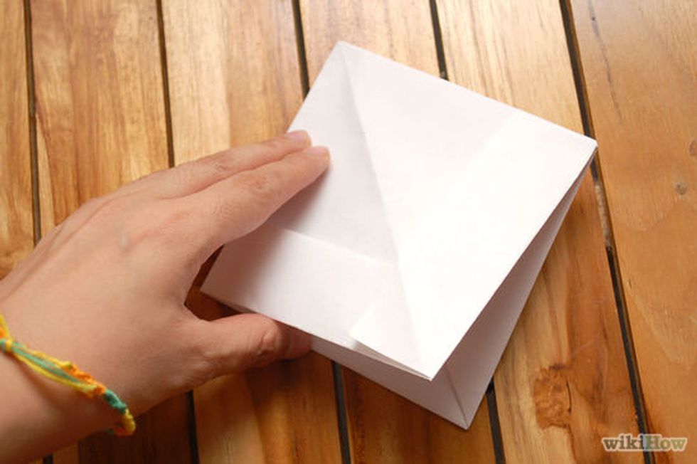 Then put your hand under the paper and make a square.