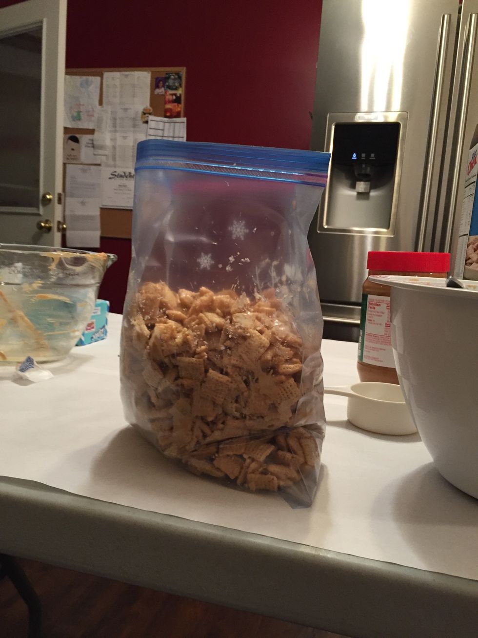 Then, put your mixture of chex and the peanut butter mix into the ziploc bag.