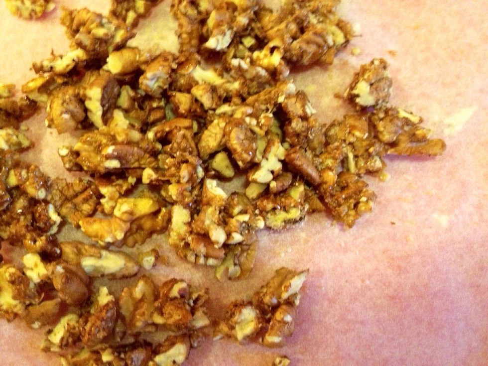 Then remove the nuts from the heat and onto a parchment paper. Let them cool somewhat and then separate them, with your fingers or a knife.