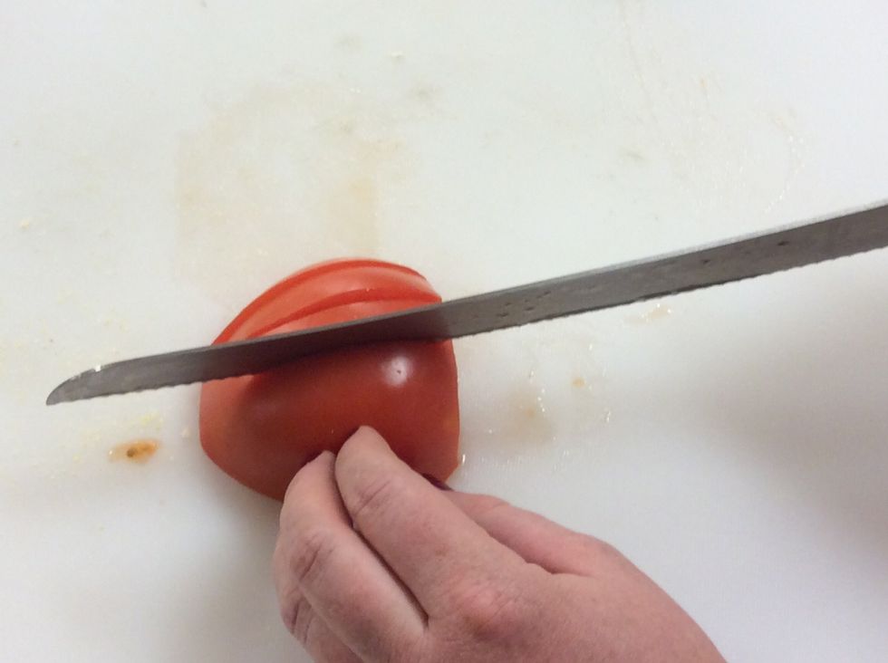 Then remove the stem end and cut the tomato length wise, try to get all of the tomato slices the same width.
