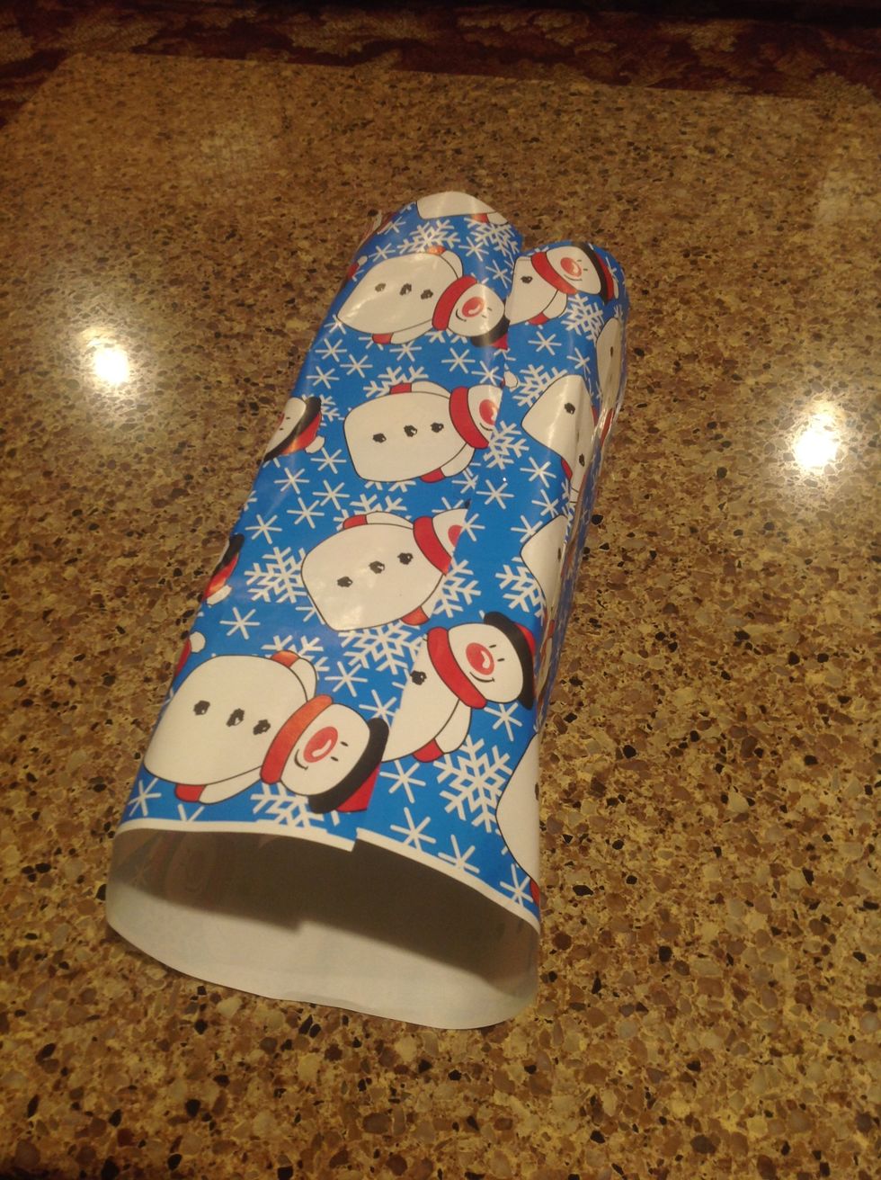 Then, repeat Step 4 with the other side and tape it down. Note: if the folded paper goes over the edge of the box, cut it as it is too long. It should end close to the middle.