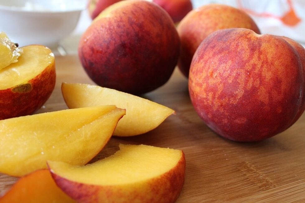 Then rinse and slice peaches into fourths.