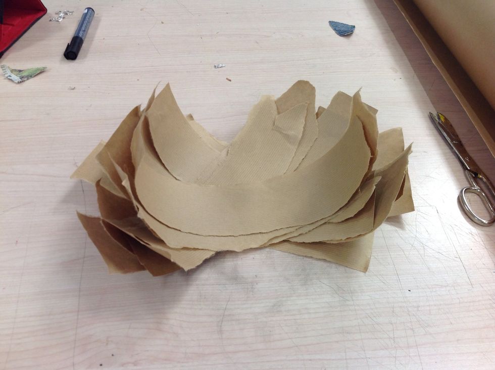 Then rip the paper into long sections. It is important to tear the paper instead of cut as it gives a more natural edge