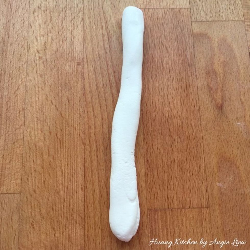 Then roll each portion of dough starting with the white dough into a long roll.