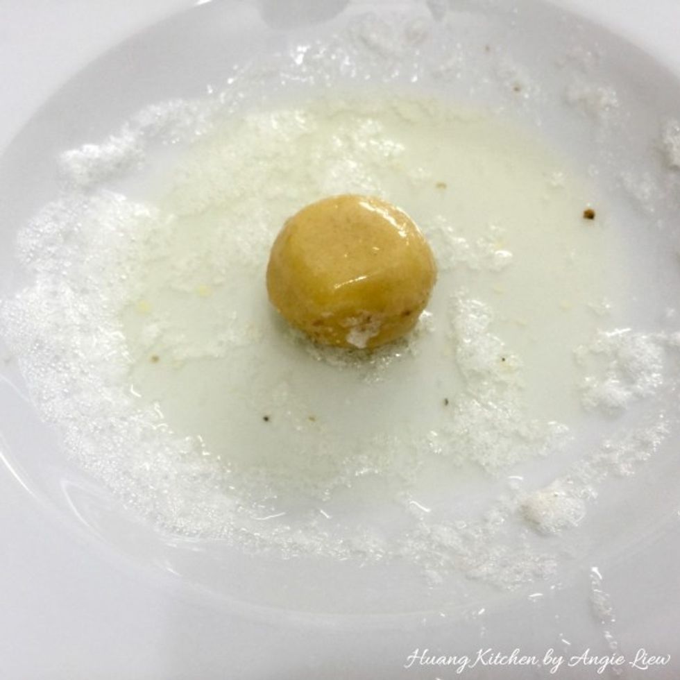 Then roll the dough ball in the whisked egg white. The egg white acts like a glue.