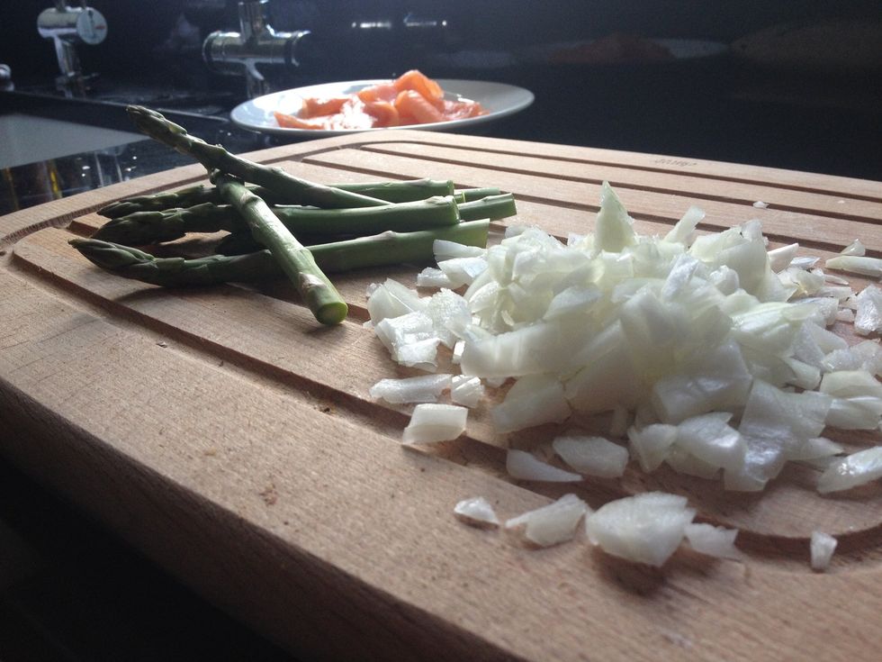 Then, roughly chop your onions and take the tough ends off of the asparagus spears.