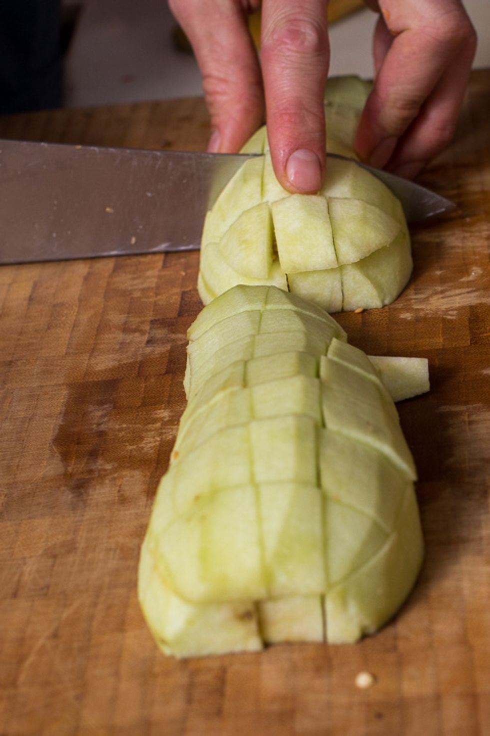 then separate them into halves and cut more vertical slices to produce long sticks. Then turn them 90 degrees, keeping them in their natural shape and cube them.