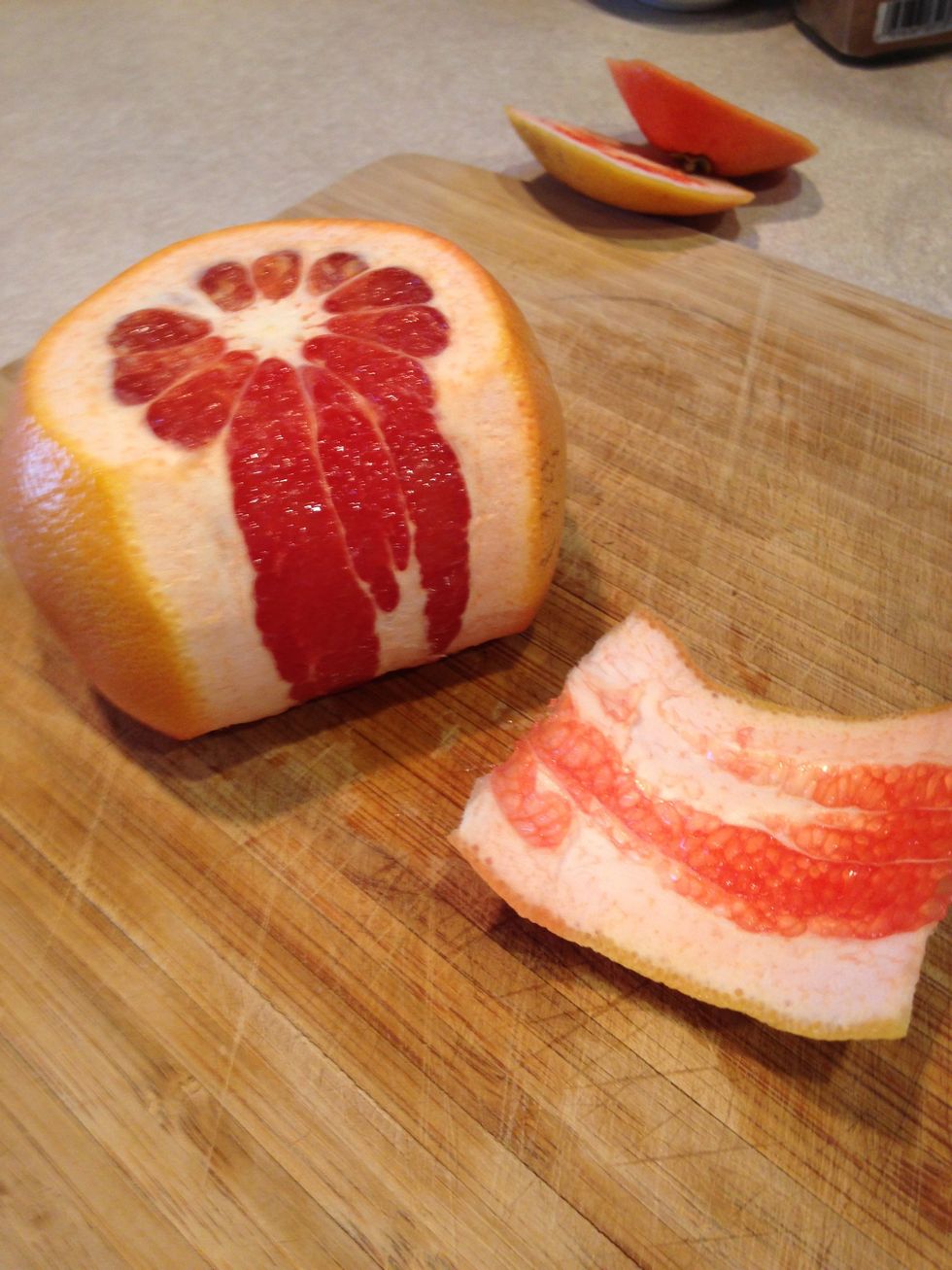 Then slice off the skin of the grapefruit, leaving as much flesh as possible.