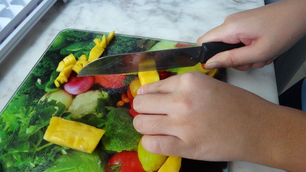 Then, slice the mango into small cubes.