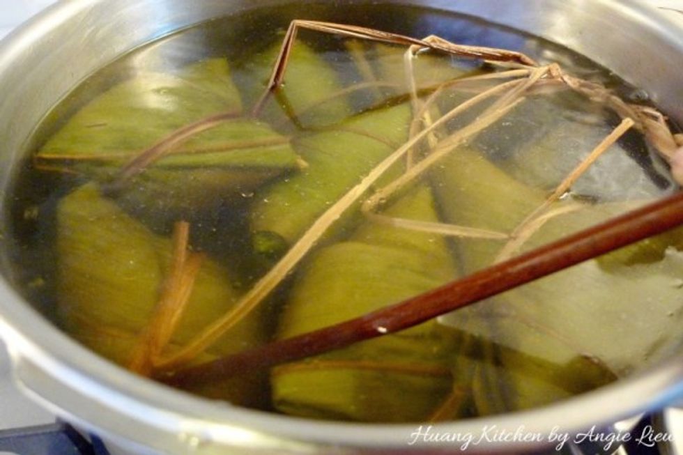 Then slowly place the dumplings into the water, making sure they are fully submerged. Cover the pot with lid and cook slowly over medium heat for about 3 hours, depending on size.