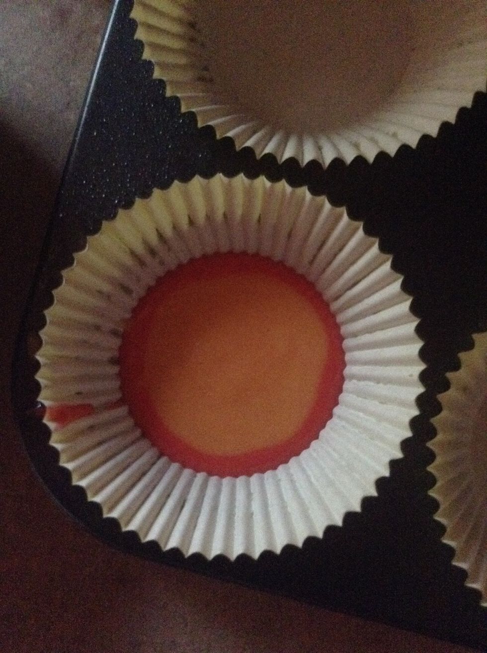 Then spoon one teaspoon of the orange batter into the center on top of the red batter. Continue this step yellow,green,blue and purple batter.