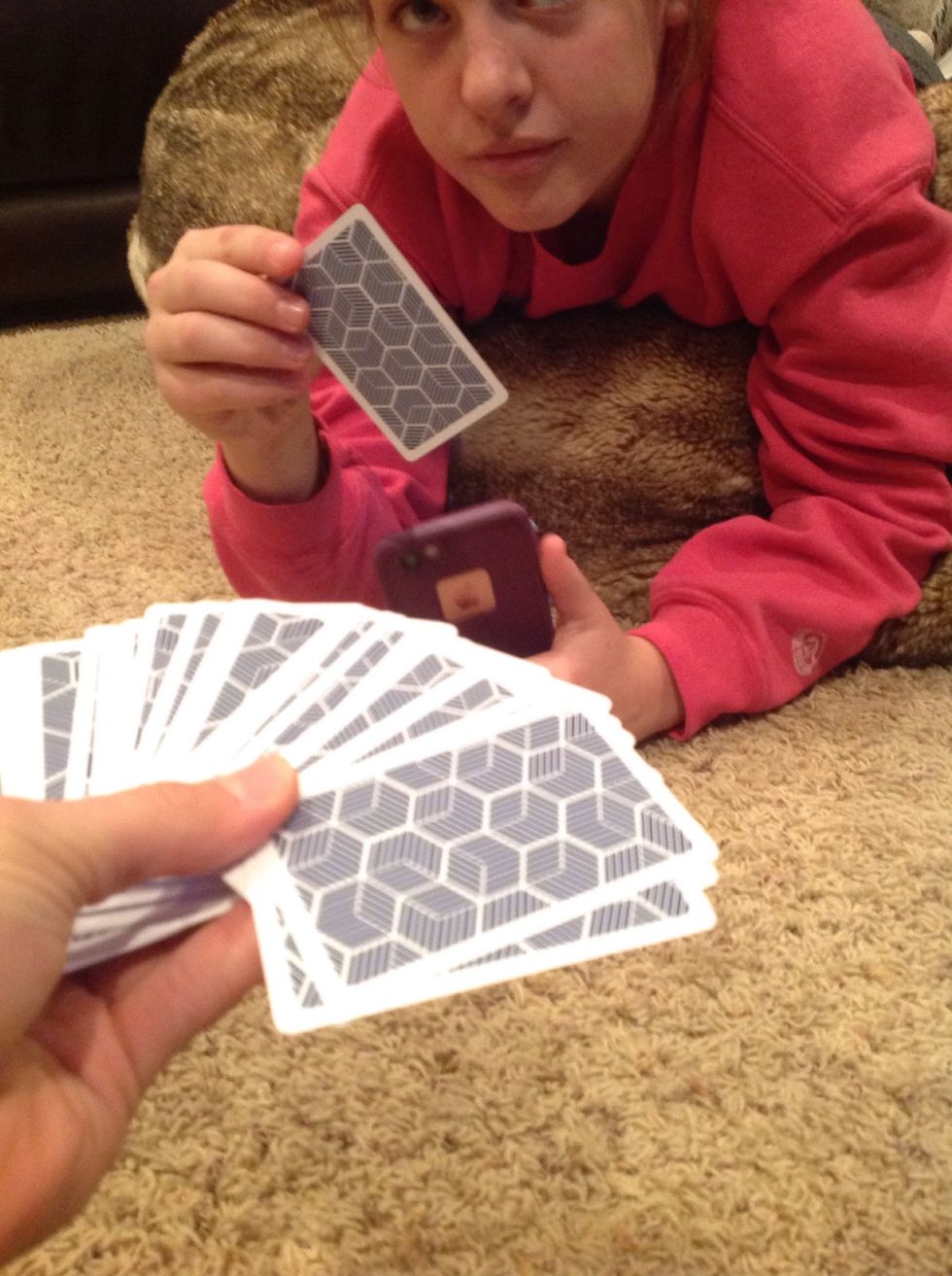 Then spread out the cards in your hand and ask the volunteer to pick any card. Tell them to look at the card and memorize it.
