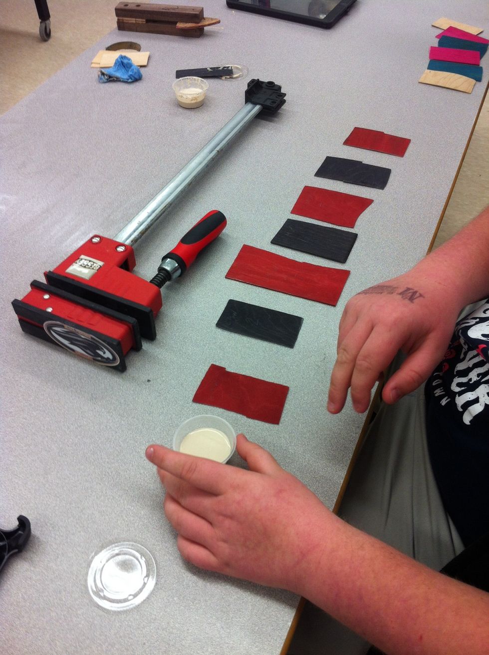 Then spread the glue with your figr or a Popsicle stick make sure You glue both sides of the veneers .