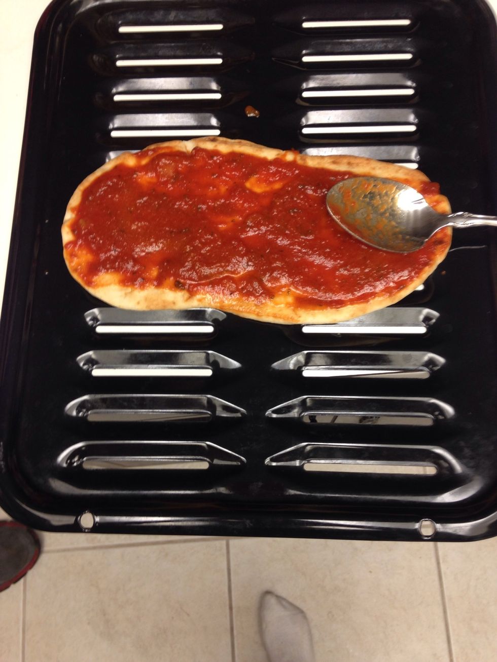 Then spread the sauce on the flatbread.