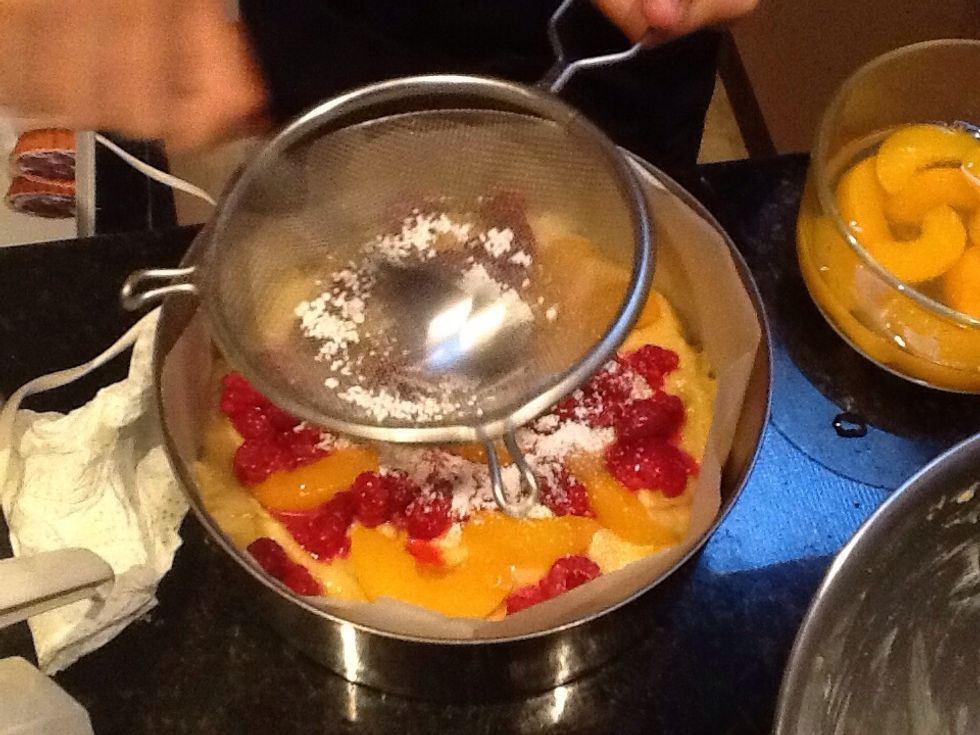 Then sprinkle sliced peaches, raspberries and icing sugar