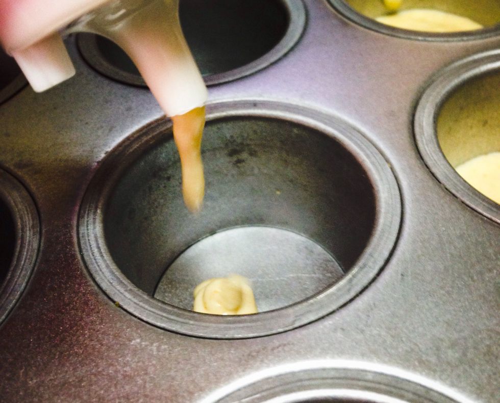 Then start adding it to the mini cake molds.