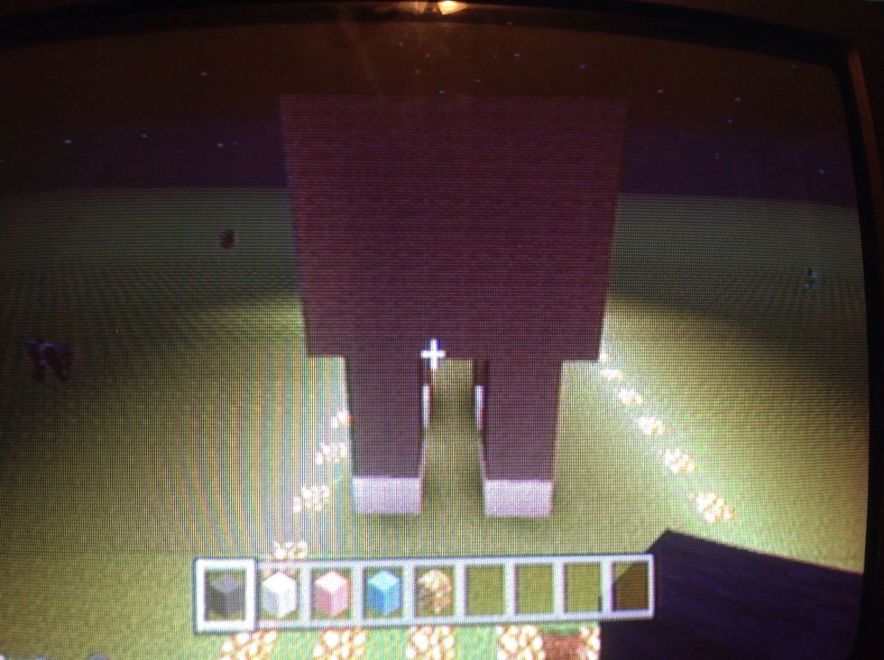 Then start body by the front legs . 8 blocks wide of gray and 5 blocks tall of gray .