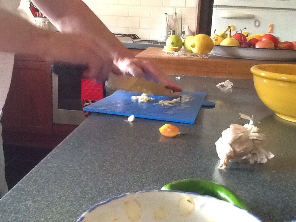 Then start chopping up your cloves of garlic