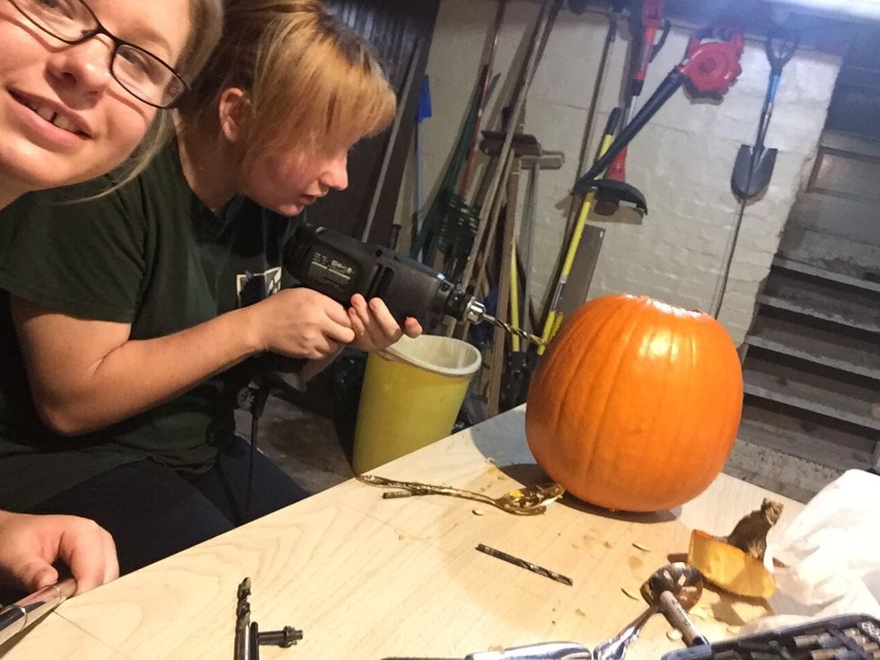 Then start drilling the pumpkin where the sharpie lines are at.