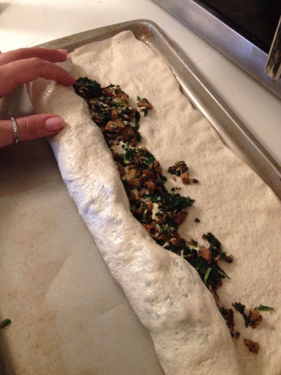 Then start to roll one edge. You can place a wax sheet under the dough if you find it difficult to roll just with your hands.