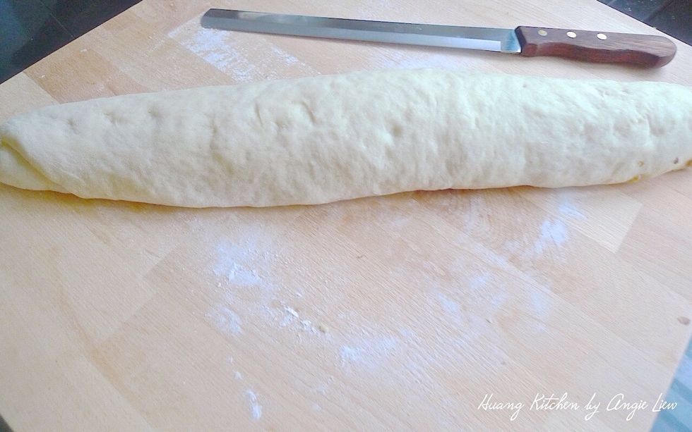 Then starting at the long end, roll up the dough like a jelly roll. Pinch the seam to seal it.