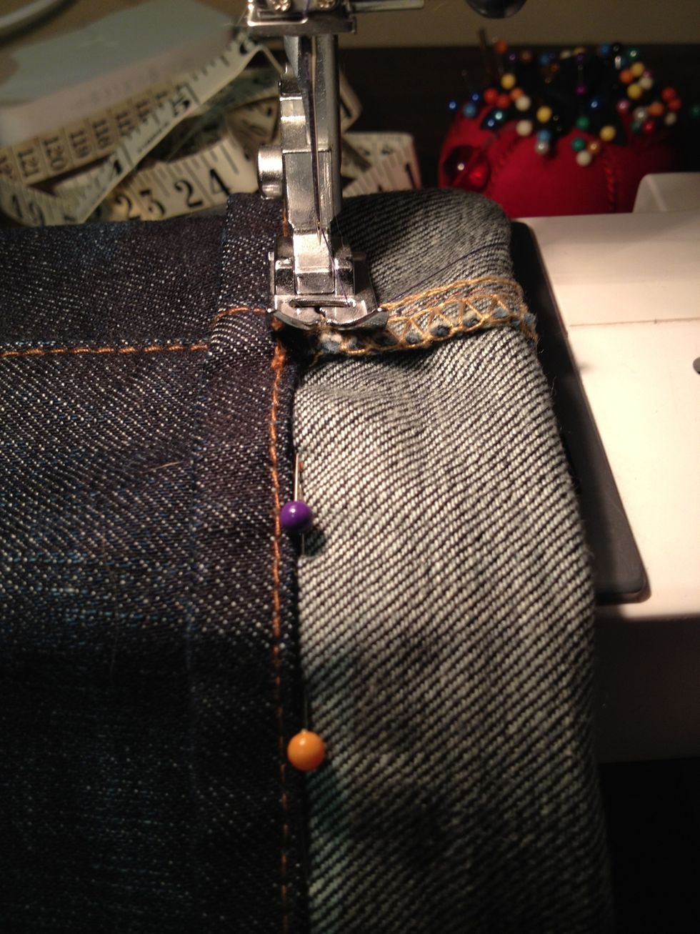 Then, starting at the side seam, start sewing your jeans as close the the underside of the original hem as possible. Make sure you dont sew your jean leg closed!