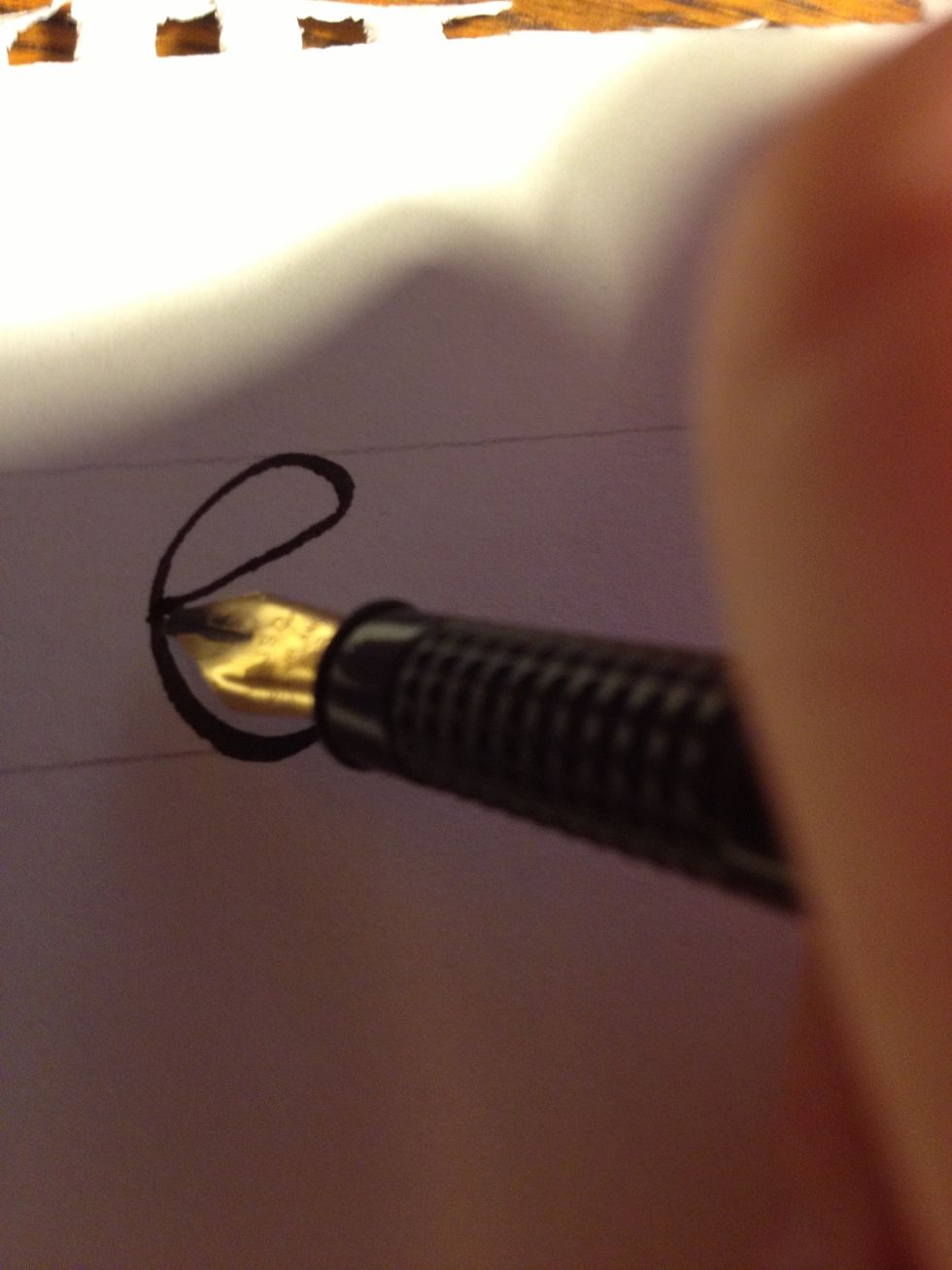Then, starting at the tic at the top of the "c", make a slightly curved line with the thin edge of your nib traveling about 45 degrees downward until it curves up just before meeting the first stroke.