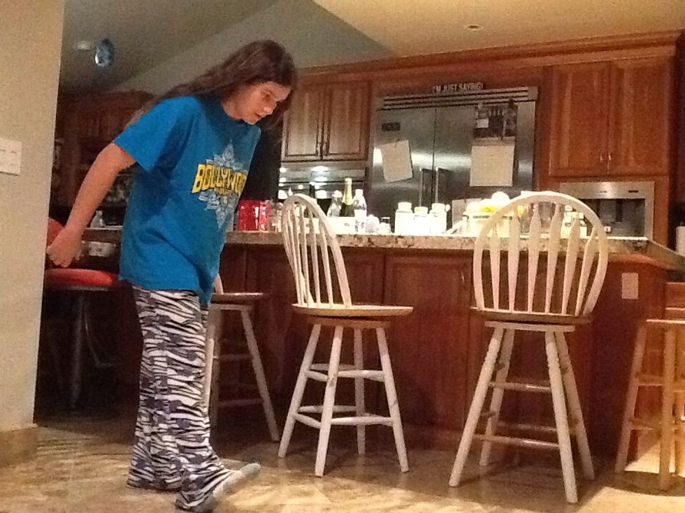 Then swing your arms back, but when your swing them back, they have to swing back straight. Your front foot should be up.