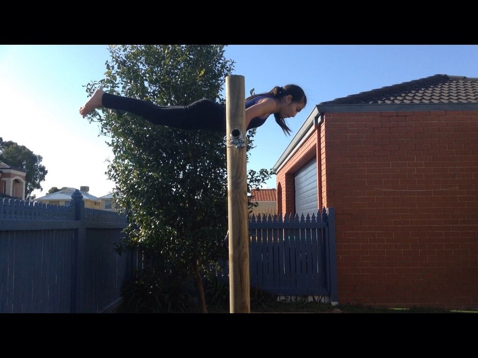 Then swing your legs back and try to get your body horizontal while having your hands still attached to the bar. The picture above is what this should look like.