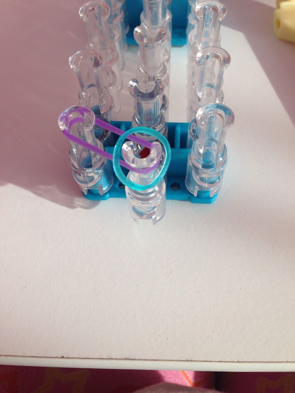 Then take a another rubber band and place it in the middle.