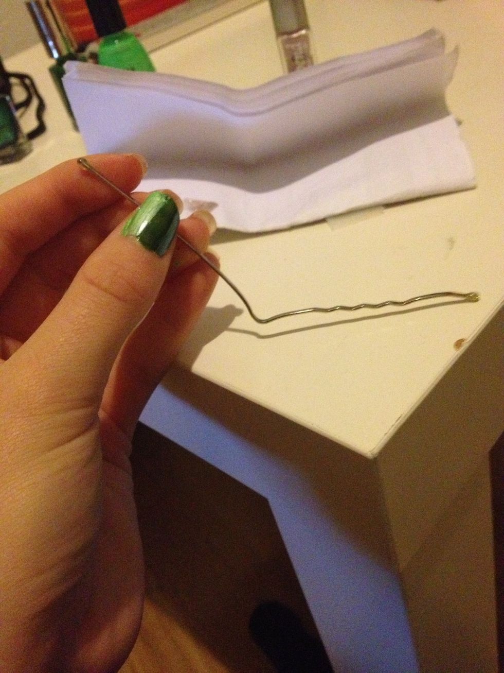 Then take a bobby pen or a dotting toll.  I'm taking my bobby pen and dip it in the polish.