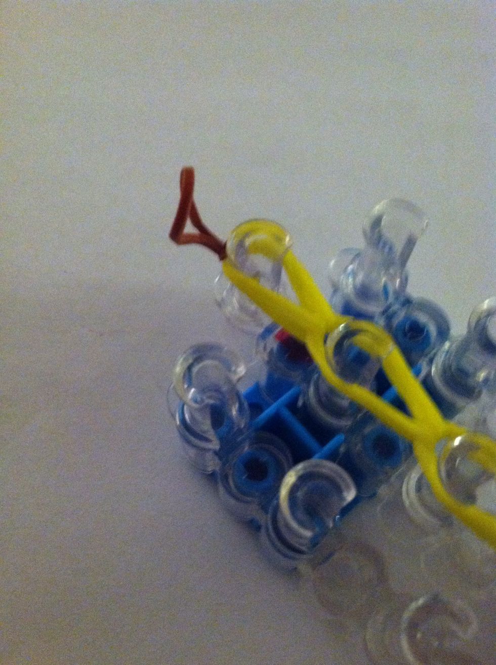 Then take a brown band and slip it in your last loop and make a slip knot to secure it