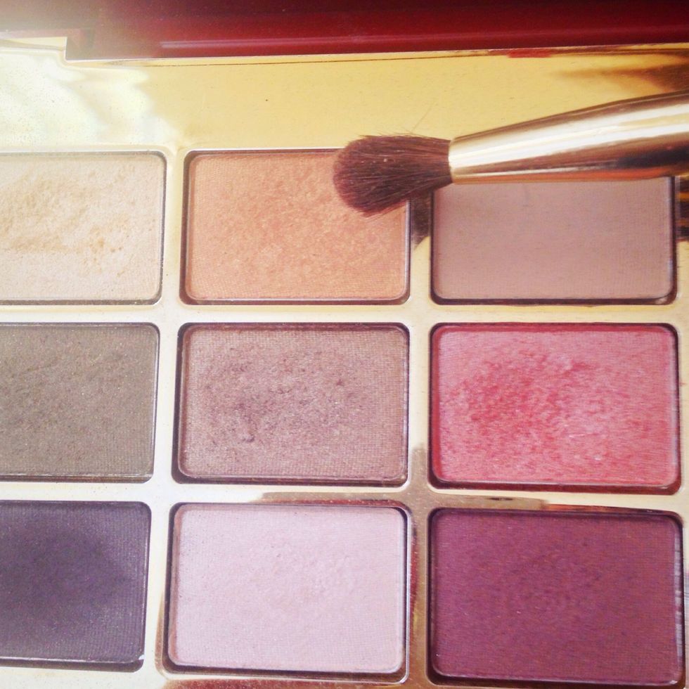 Then take a orange shade to apply in the crease with a small blending brush and blend upwards toward your eyebrows