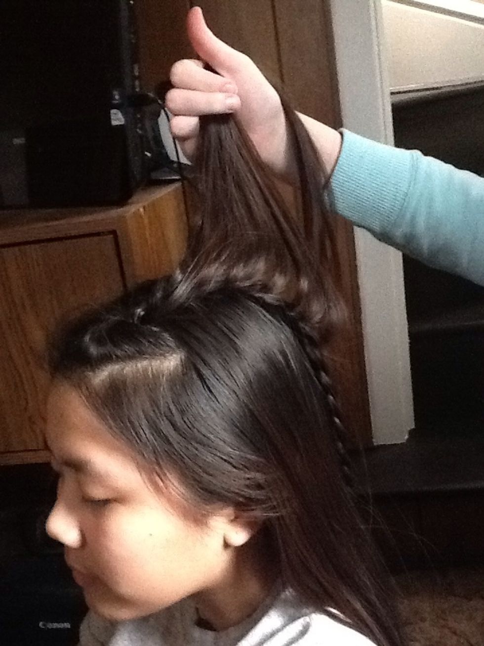 Then take all of the hair you left out, and put it to the opposite side of her head.