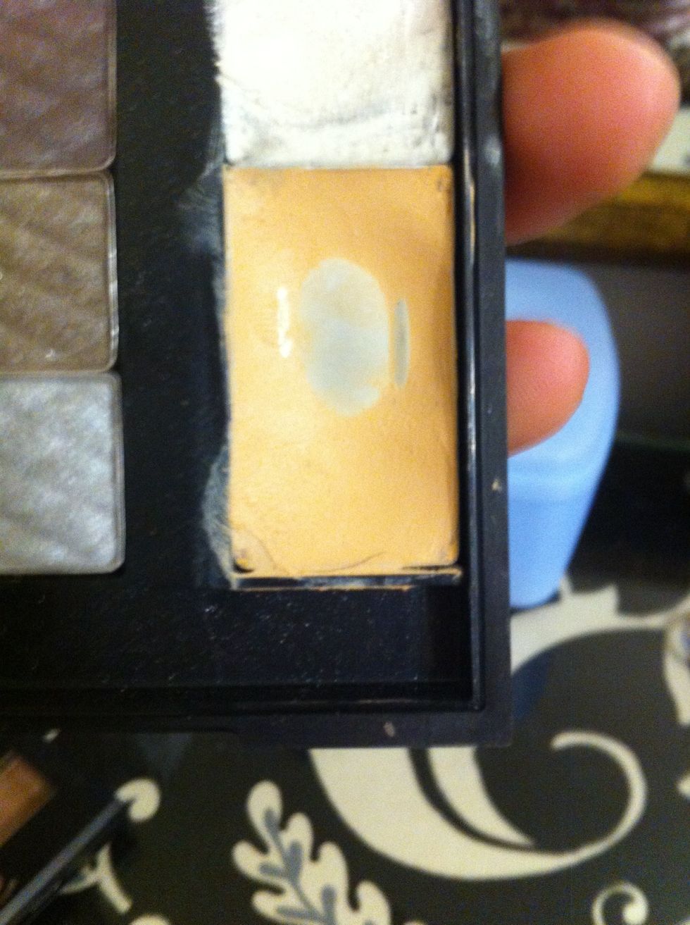 Then take and put your concealer on. I dab it under my eyes and on any blemishes.