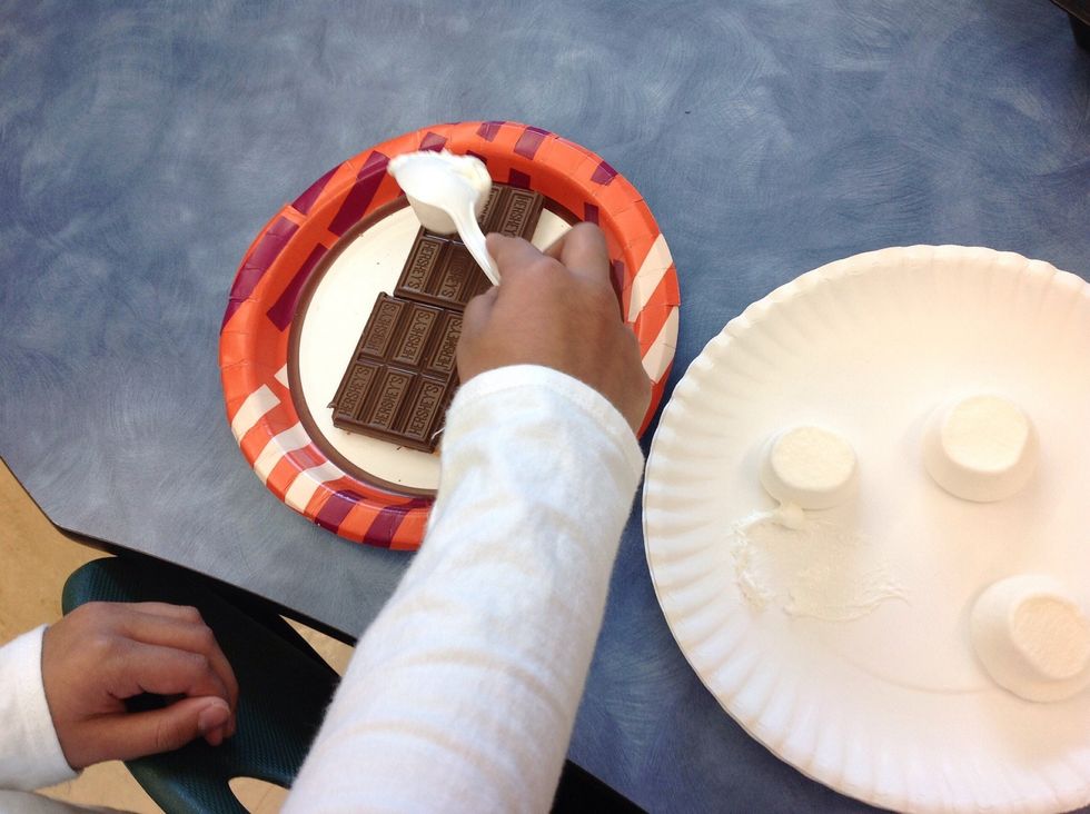 Then, take out the marshmallows. Then you place them on top of the chocolate.