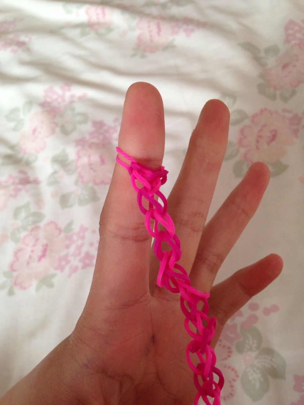 Then take the band from your middle finger and pull it onto your pointer finger.