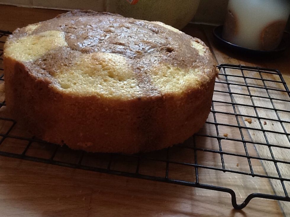 Then take the cake out of the tin and put it on the rack